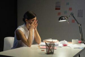 woman at desk needing therapist Arlington VA
