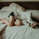 Woman under bed sheets wondering about therapist for anxiety near me
