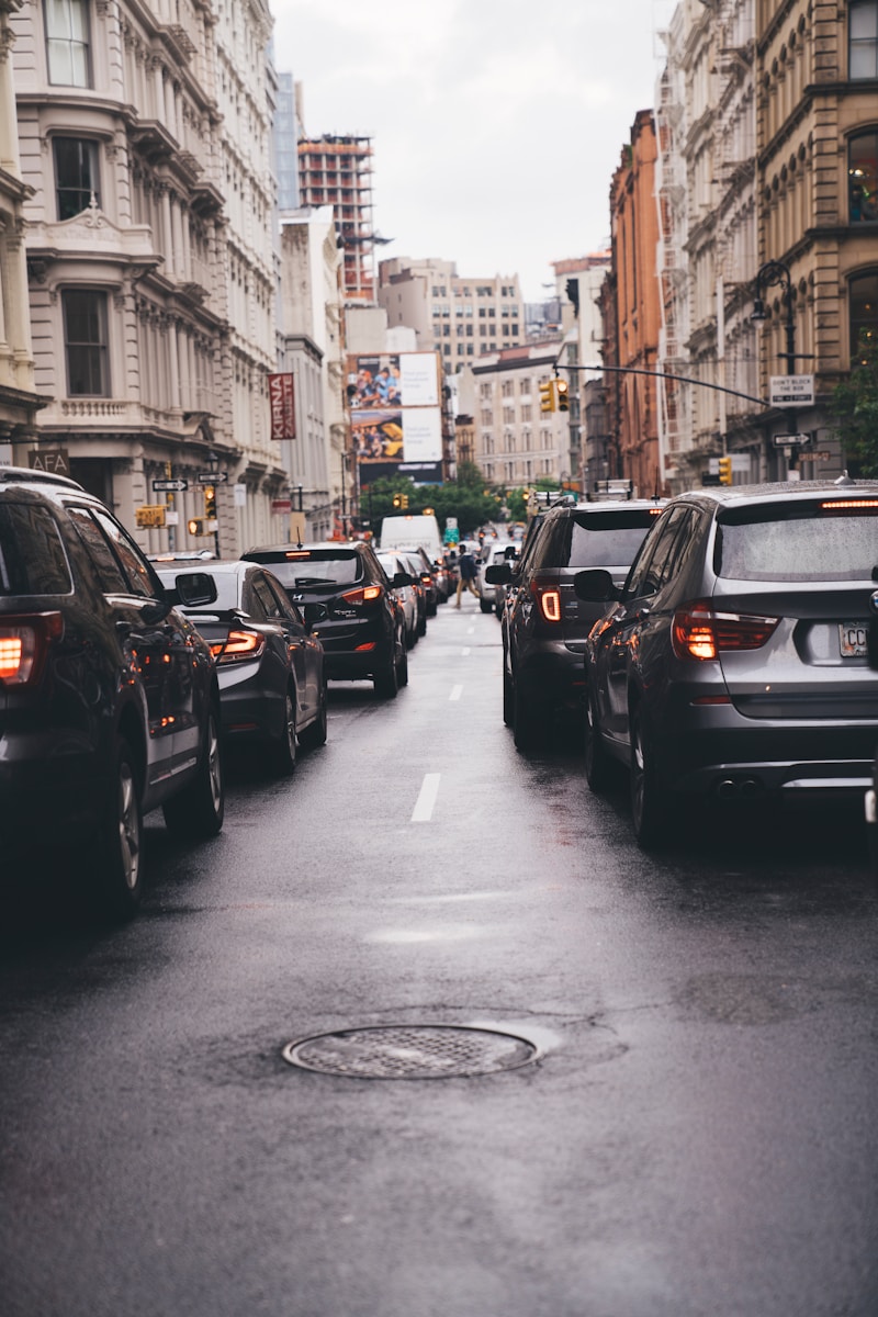 different vehicles on road viewing high-rise buildings during daytime
