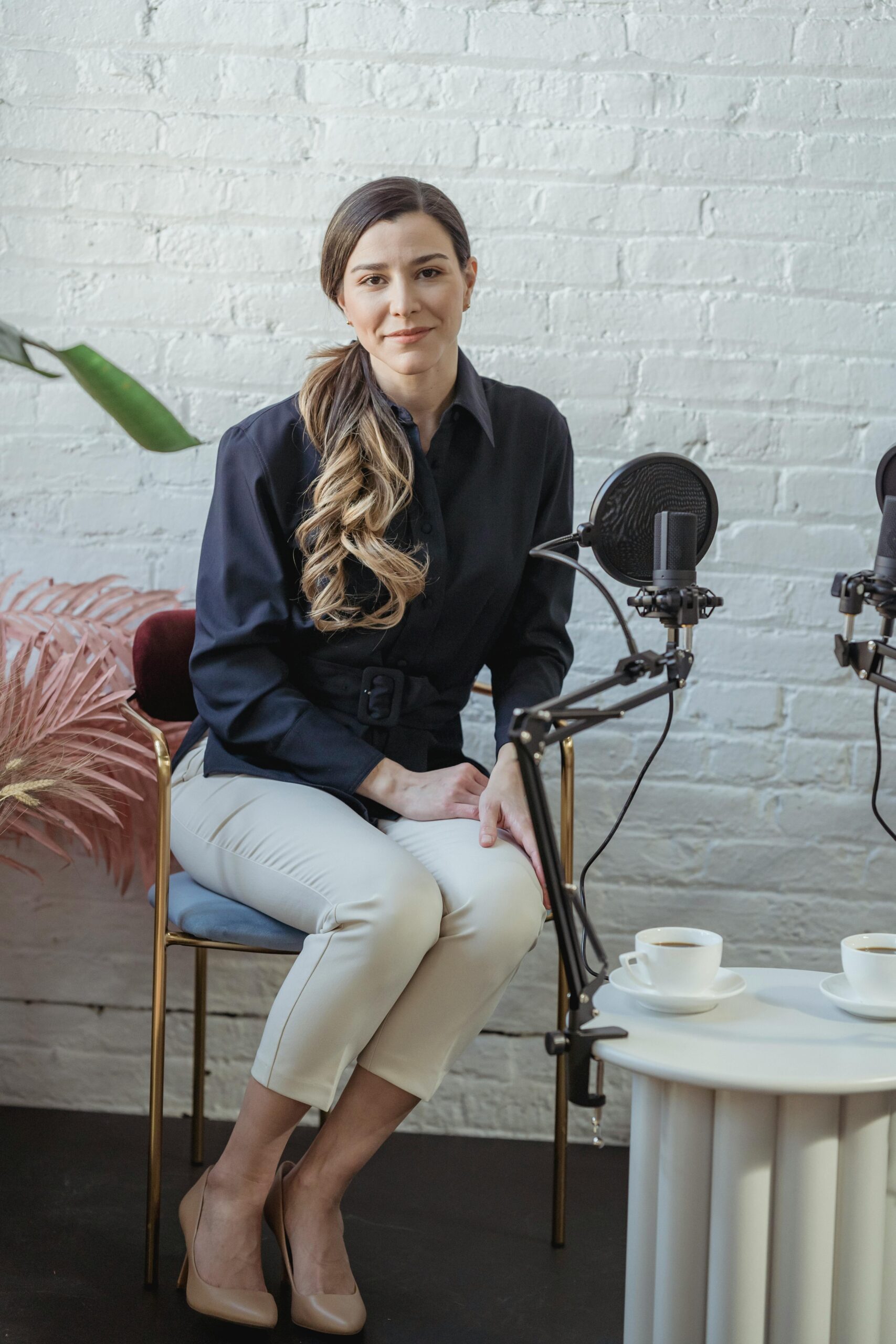 Woman sitting on couch with microphone in front of her