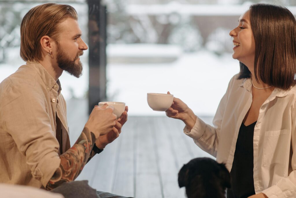 Man and woman sharing coffee together and smiling where they had previously thought, "Should I get a divorce?"